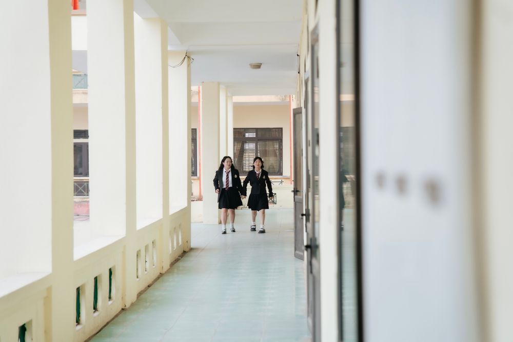 Students walking through an open school corridor
