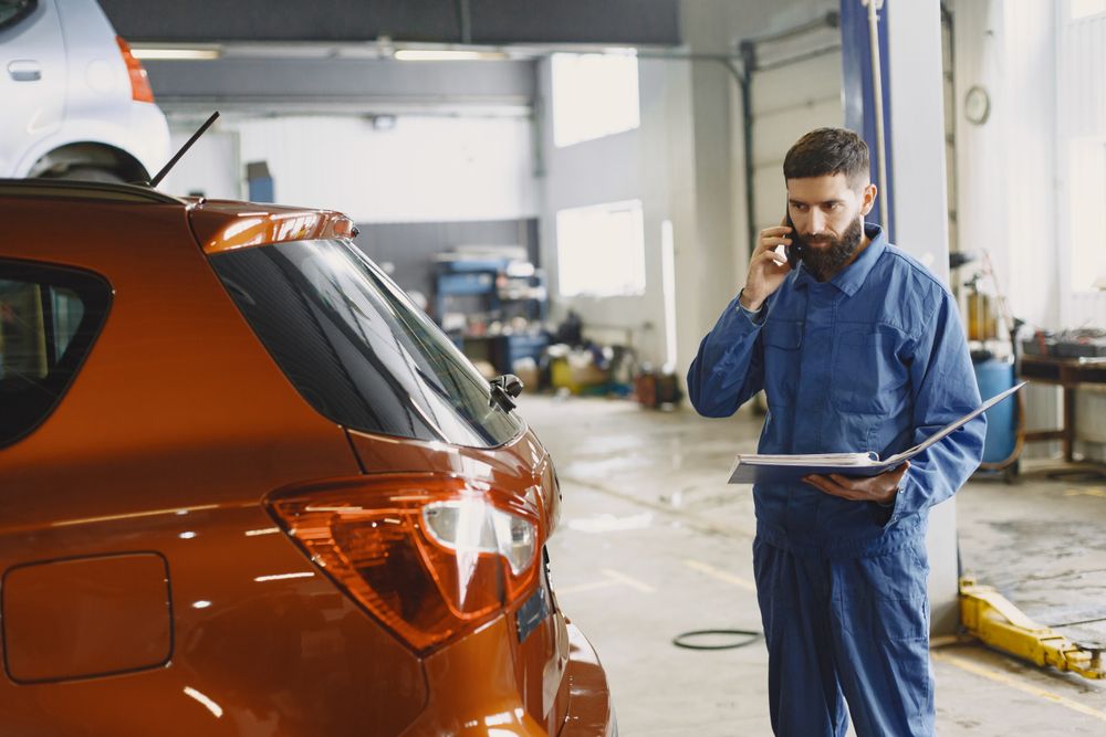 A mechanic taking a phone call in a repair shop